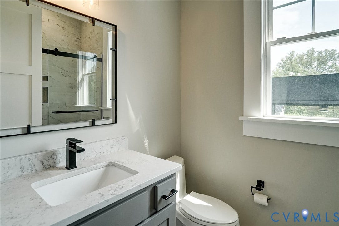 1732 Fishers Pond Drive, Maidens, VA 23102 Bathroom featuring a quartz-finish countertop, integrated sink, and modern matte black faucet
