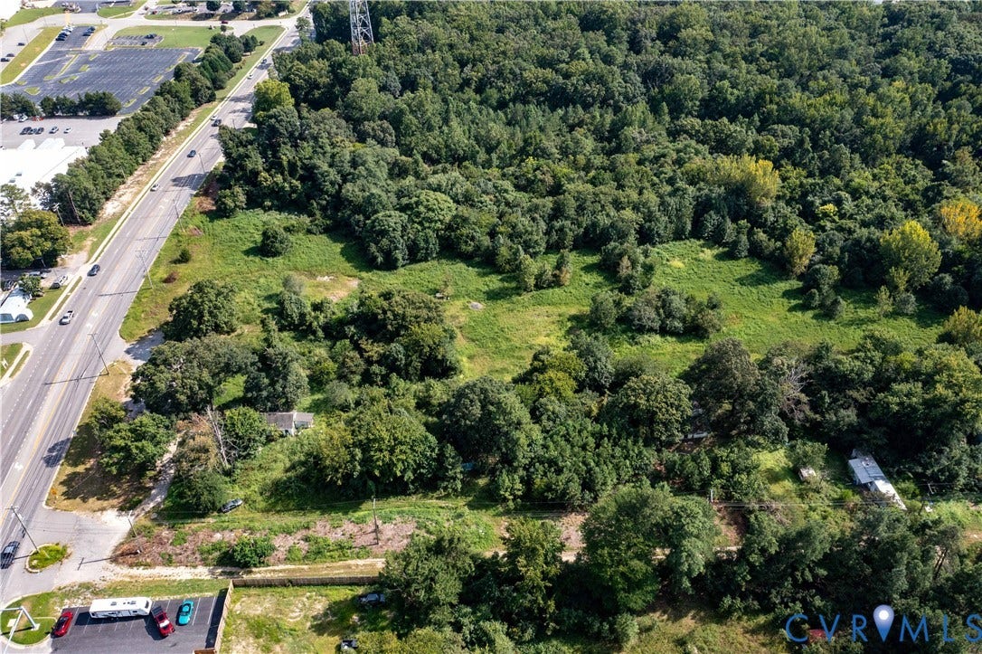 13500 Route 1, Chester, VA 23831 Expansive land parcel featuring a main road, adjacent parking area, and substantial tree coverage