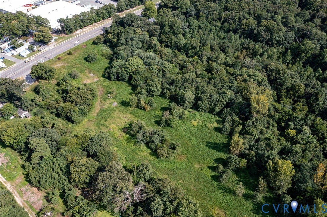 13500 Route 1, Chester, VA 23831 Expansive land parcel featuring a mix of mature trees and open grassy areas