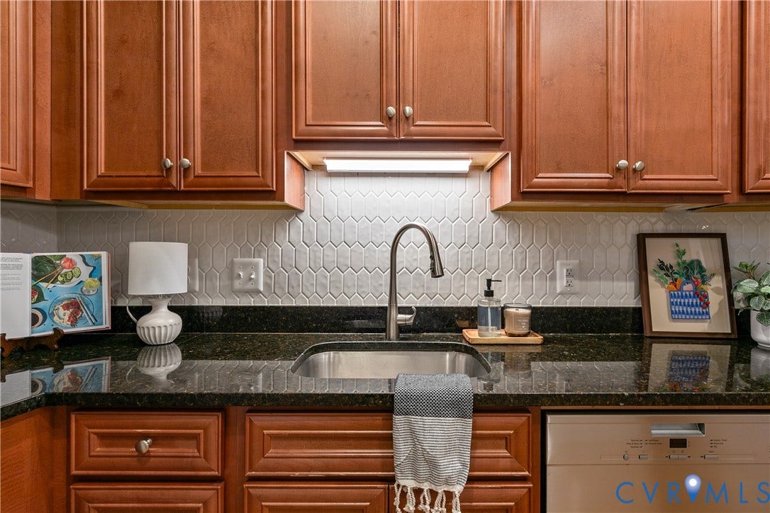 601 Roseneath Road, #U1, Museum District, Richmond, VA 23221 Kitchen featuring wood cabinetry, dark speckled countertops, and a white geometric tile backsplash