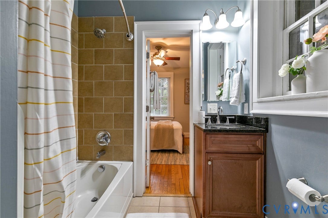 601 Roseneath Road, #U1, Museum District, Richmond, VA 23221 Bathroom featuring a shower-over-tub combination with subway tile surround, single vanity with dark countertop, and overhead light fixture