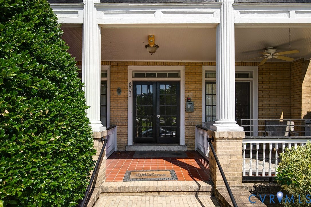 601 Roseneath Road, #U1, Museum District, Richmond, VA 23221 Brick exterior featuring a covered front porch with substantial columns, grid-pane double entry doors, a tiled landing, and black railings