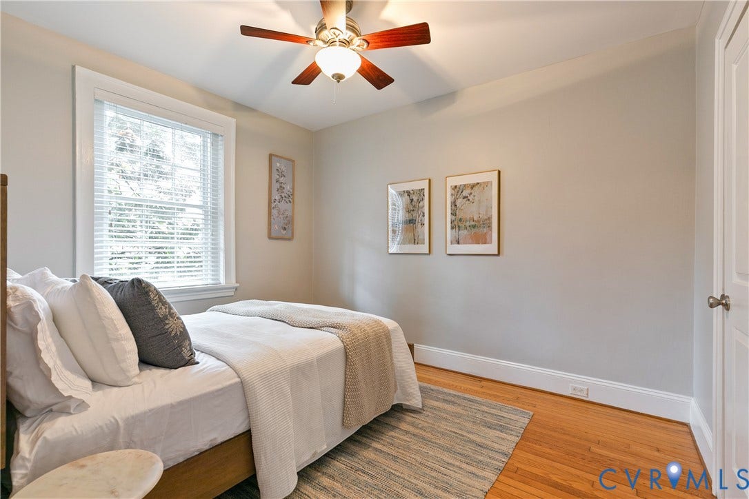 601 Roseneath Road, #U1, Museum District, Richmond, VA 23221 Hardwood flooring throughout this room, featuring a ceiling fan with light fixture, substantial baseboards, and a paneled door