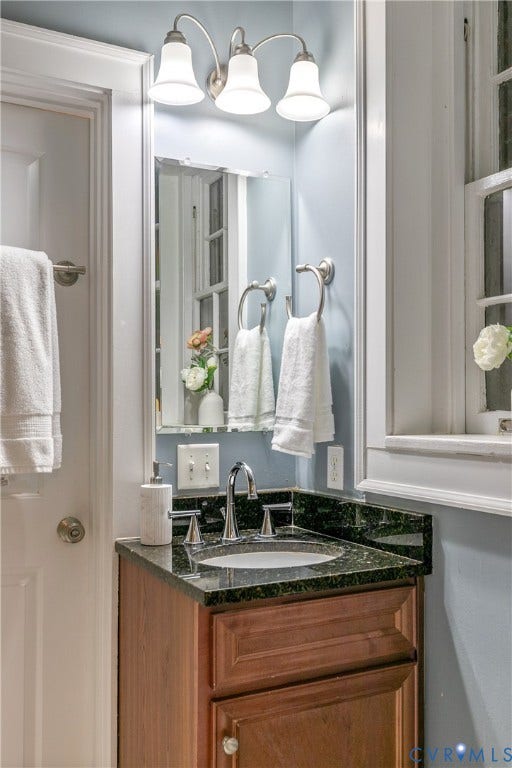 601 Roseneath Road, #U1, Museum District, Richmond, VA 23221 Bathroom vanity featuring a dark granite countertop, undermount sink, and a chrome faucet