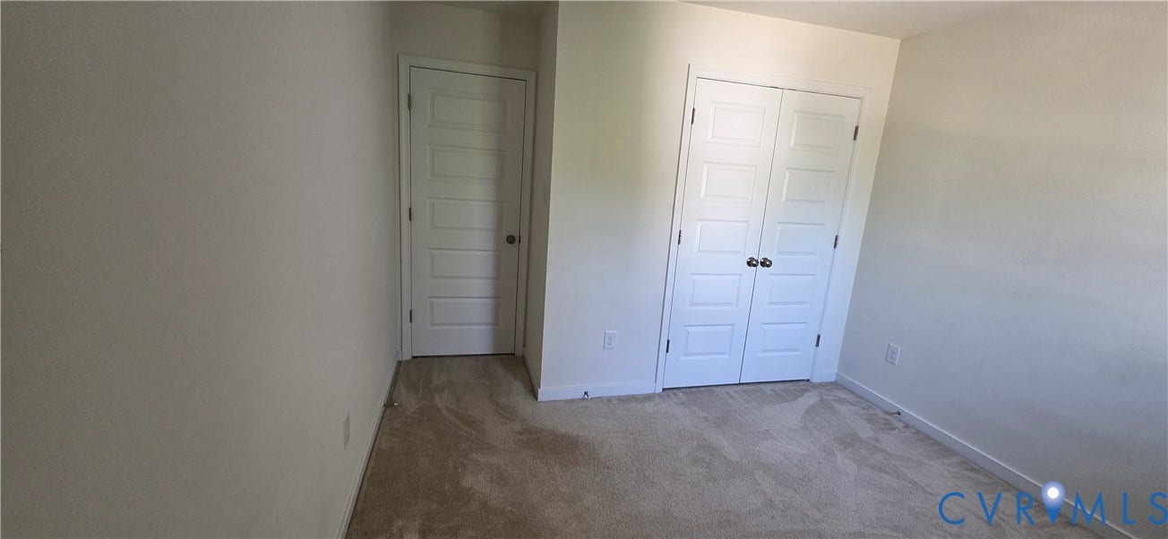 Neutral wall paint finishes a room featuring carpet flooring and white trim