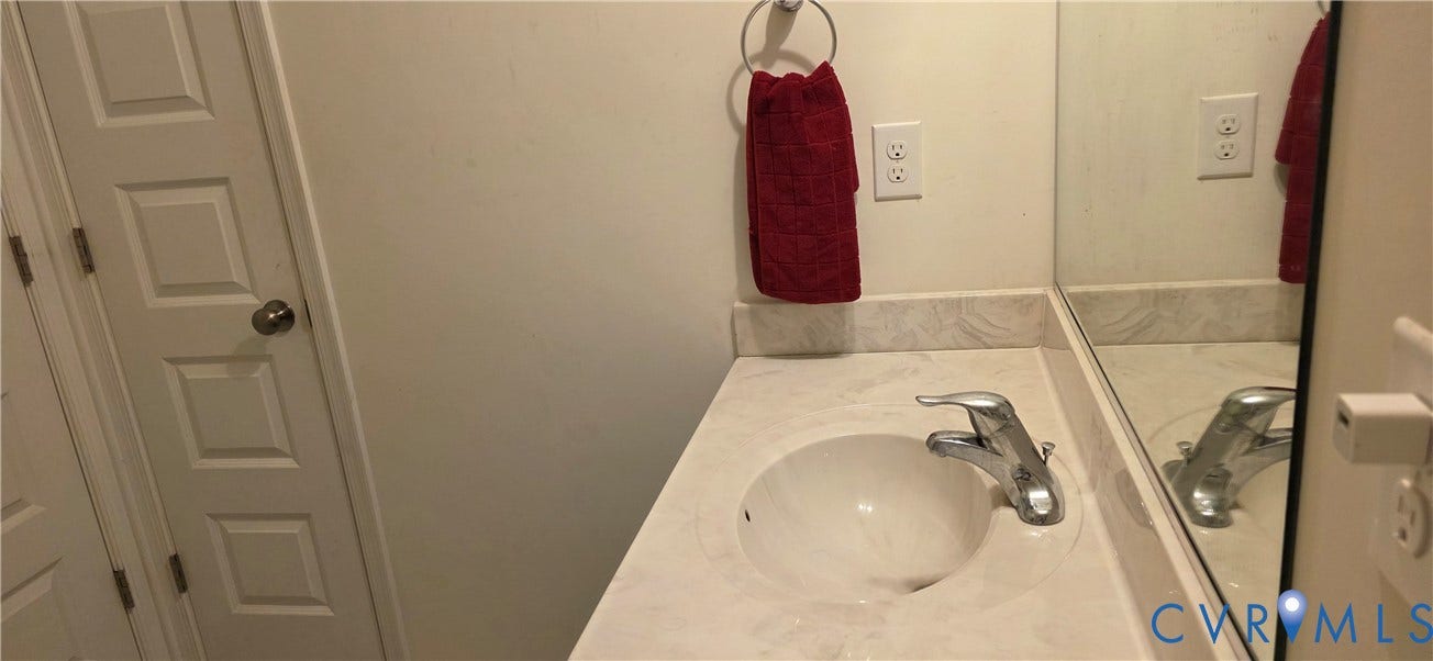 White vanity with an integrated sink and chrome faucet
