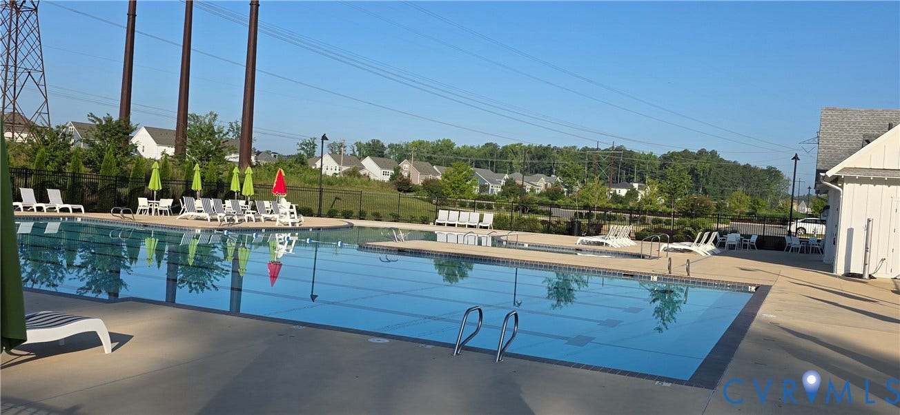 Community swimming pool with a concrete deck surround