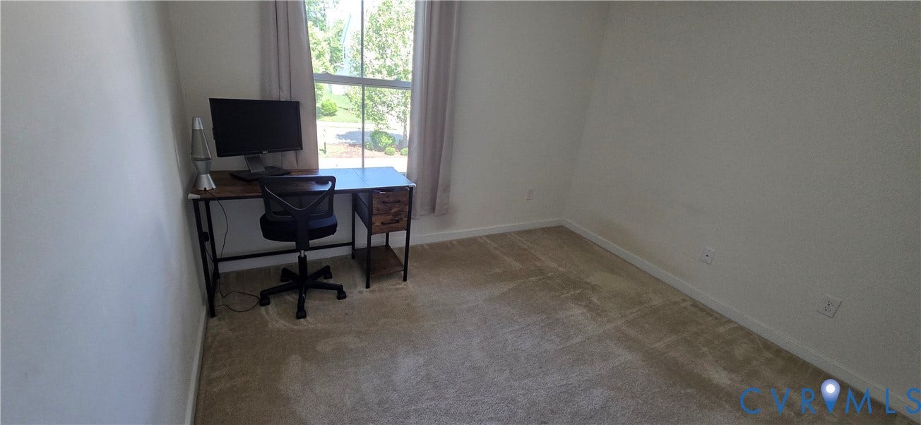 Neutral-toned wall-to-wall carpeting throughout
