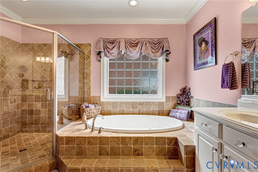 1020 Belva Court, Glen Allen, VA 23059 Bathroom featuring a built-in soaking tub with tiled surround, a glass-enclosed shower with tiled walls and floor, and a double-hung window with privacy glass blocks