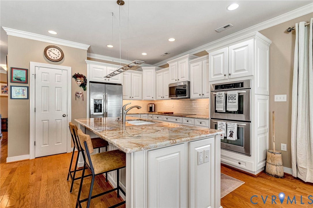 1020 Belva Court, Glen Allen, VA 23059 Kitchen featuring a large island with stone countertop, white cabinetry, stainless steel appliances, and wood-finish flooring