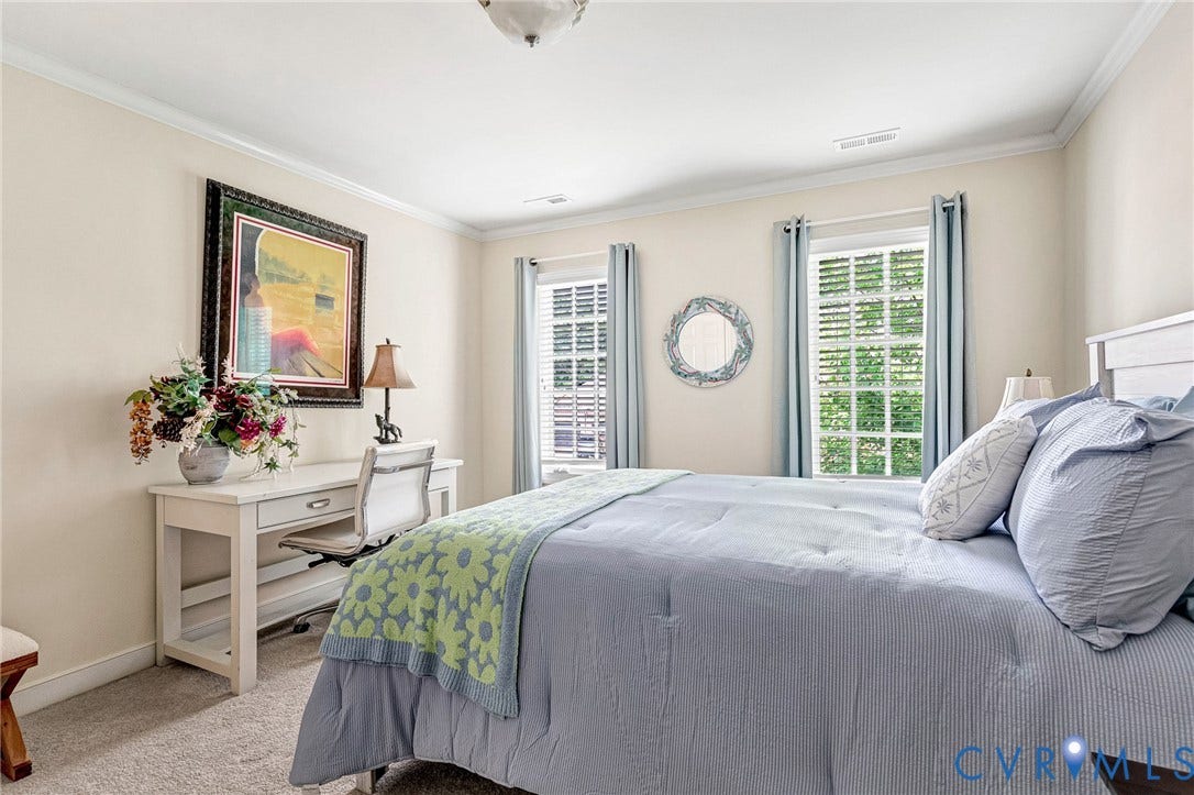 1020 Belva Court, Glen Allen, VA 23059 Carpeted room featuring a white bed frame, two windows with white plantation shutters, and crown molding