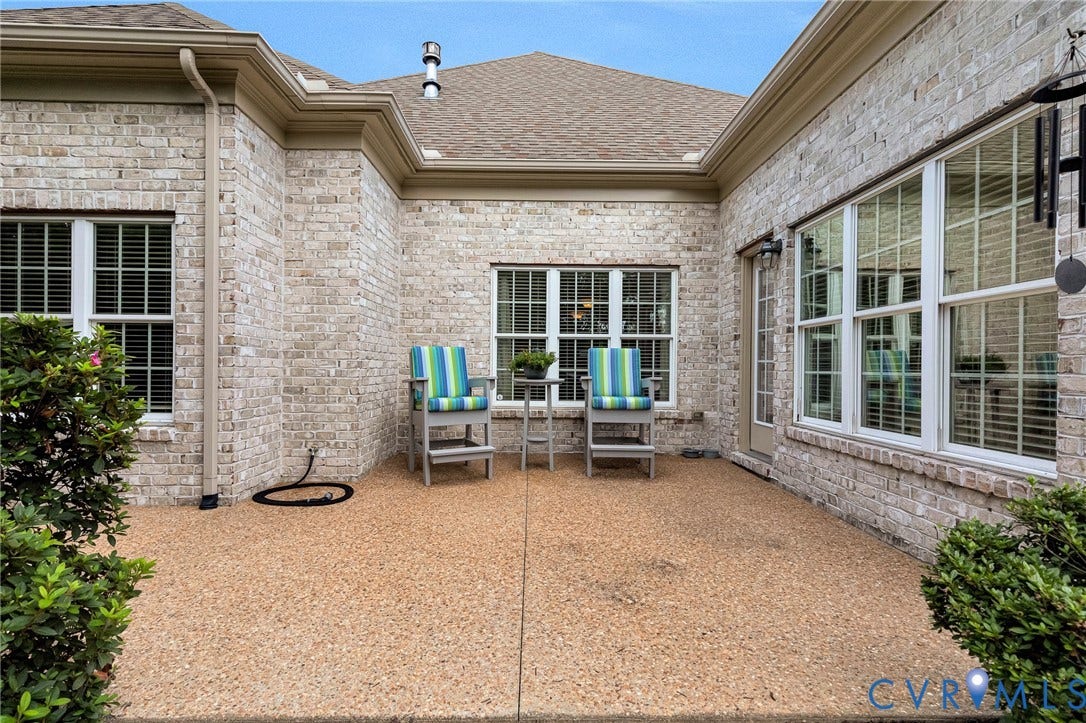 1020 Belva Court, Glen Allen, VA 23059 Expansive outdoor patio featuring an exposed aggregate finish and brick facade