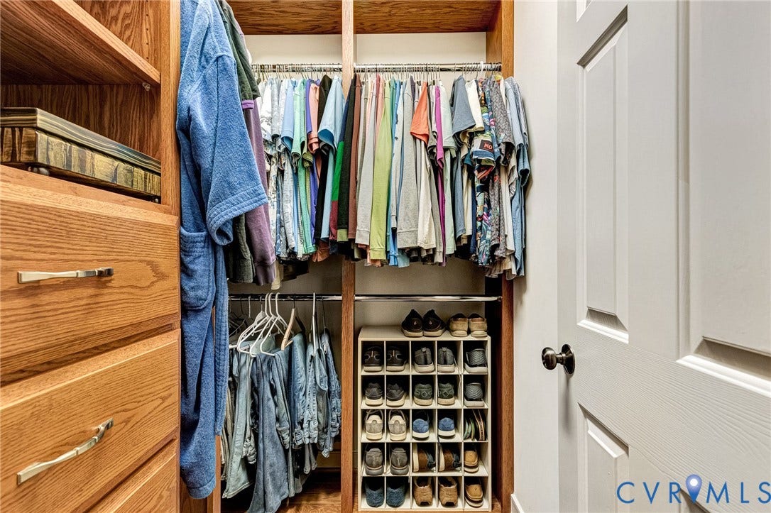 1020 Belva Court, Glen Allen, VA 23059 Custom closet system featuring built-in wood-finish drawers, shelving, and metal hanging rods