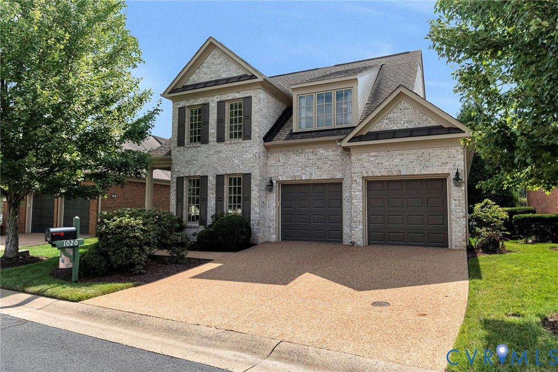 1020 Belva Court, Glen Allen, VA 23059 Traditional style residence featuring a light-colored brick facade, dark window shutters, and a two-car garage with panel doors