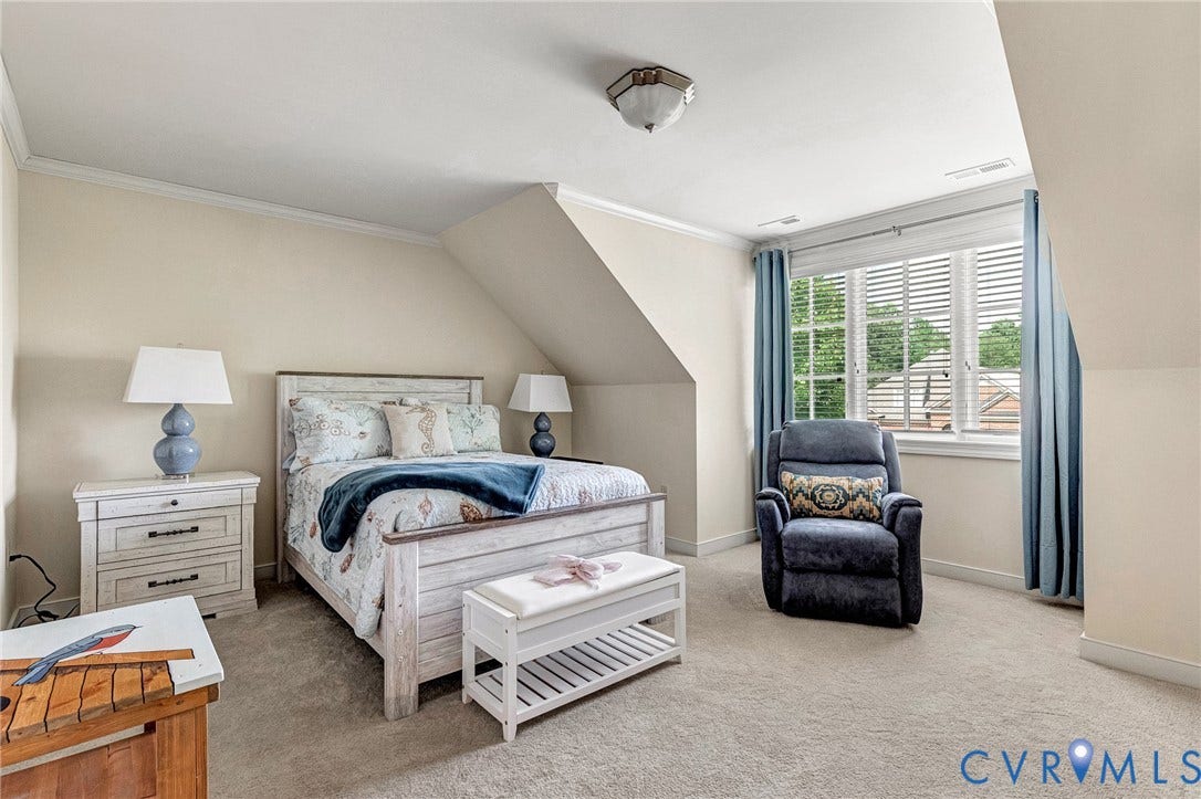 1020 Belva Court, Glen Allen, VA 23059 Carpeted room featuring a window with white blinds and blue curtains, crown molding, and an angled ceiling