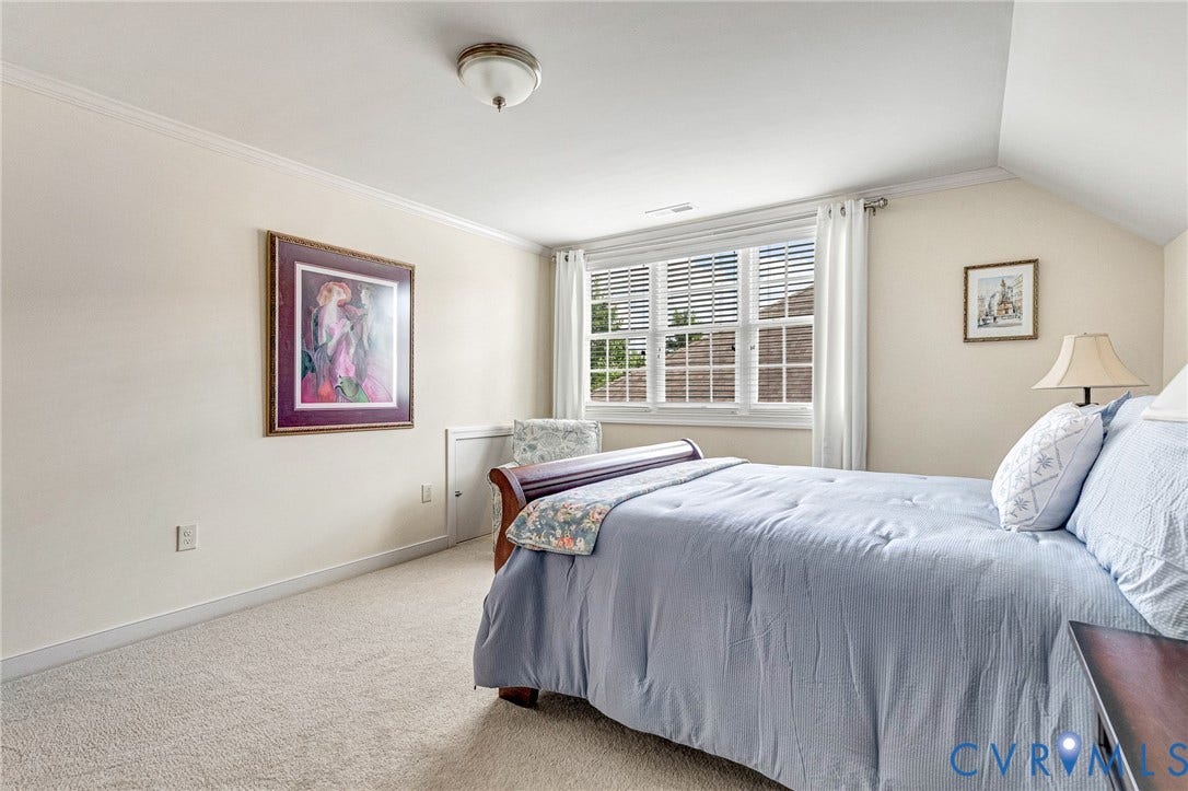 1020 Belva Court, Glen Allen, VA 23059 Bright room featuring a large window with blinds, carpeted flooring, crown molding, and a sloped ceiling detail