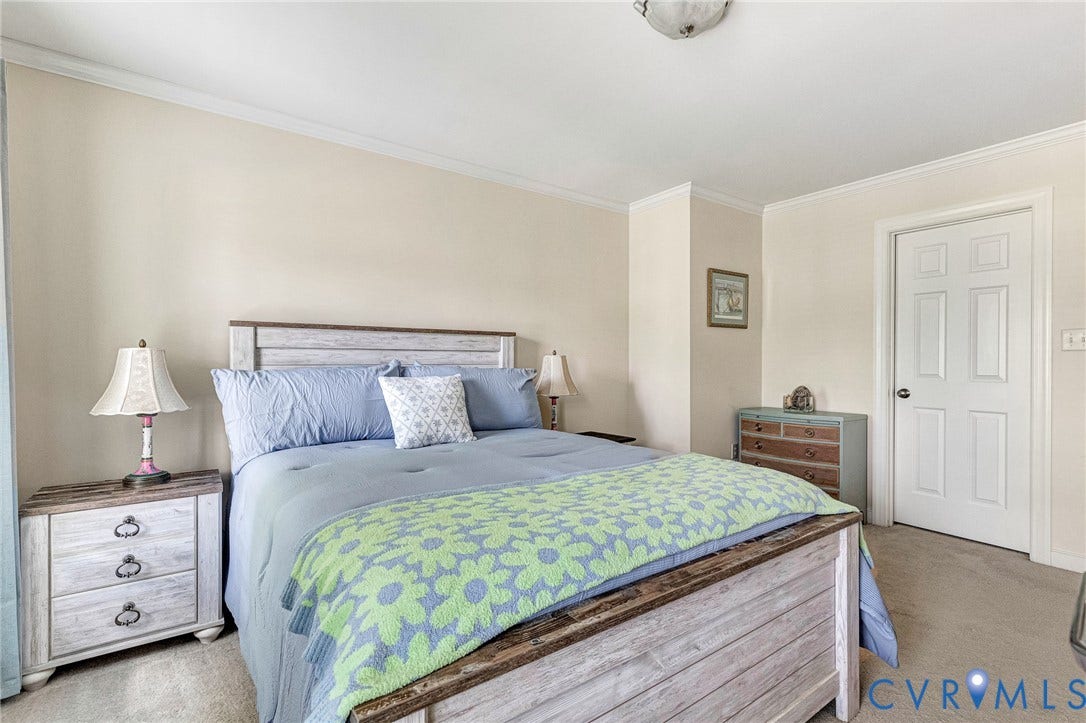 1020 Belva Court, Glen Allen, VA 23059 Carpeted bedroom featuring a paneled interior door, crown molding, and neutral wall tones