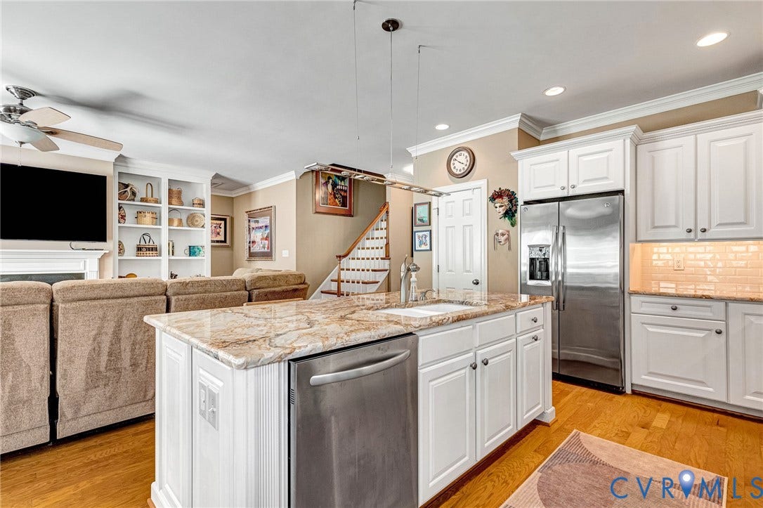 1020 Belva Court, Glen Allen, VA 23059 Kitchen island featuring a built-in sink and stainless steel dishwasher