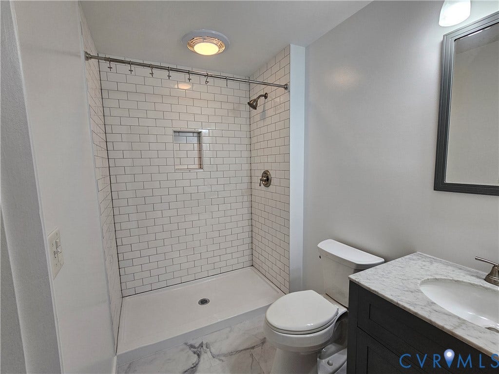 14600 Ramblewood Drive, Chester, VA 23836 Subway tile shower with built-in niche, white shower base, and brushed nickel fixtures