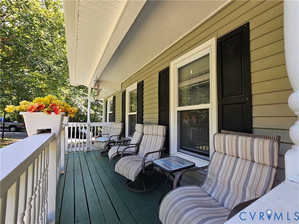 14600 Ramblewood Drive, Chester, VA 23836 Covered porch with a painted wood floor, white railing, and exterior siding