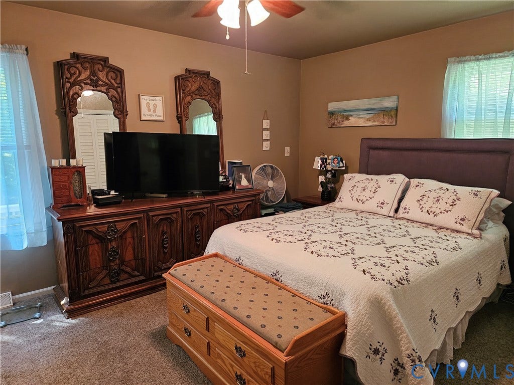 14600 Ramblewood Drive, Chester, VA 23836 Carpeted flooring, ceiling fan, and window with blinds