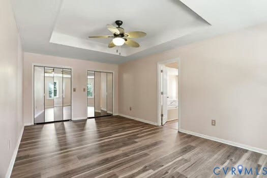 2804 Executive Drive, John Tyler Woods, Chester, VA 23831 Spacious room featuring LVP flooring, a tray ceiling with a ceiling fan light fixture, and two sets of mirrored bi-fold closet doors
