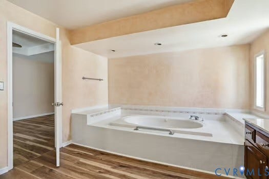 2804 Executive Drive, John Tyler Woods, Chester, VA 23831 Soaking tub with a white surround, integrated deck, and chrome fixtures
