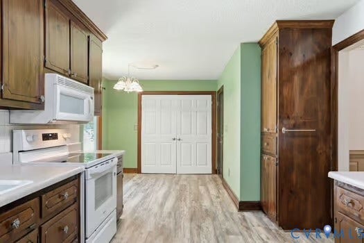 2804 Executive Drive, John Tyler Woods, Chester, VA 23831 Kitchen featuring wood-finish cabinetry, white countertops, and LVP flooring