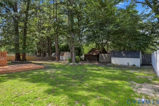 2804 Executive Drive, John Tyler Woods, Chester, VA 23831 Expansive backyard with a vibrant lawn, featuring a large wooden deck