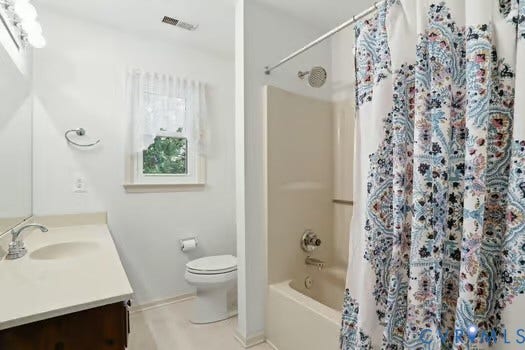 2804 Executive Drive, John Tyler Woods, Chester, VA 23831 Full bathroom featuring a white vanity with an integrated sink, a white toilet, and a combination shower/tub