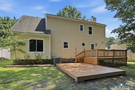 2804 Executive Drive, John Tyler Woods, Chester, VA 23831 Expansive backyard featuring a large wooden deck with railing, a ground-level wooden patio, and light-colored siding