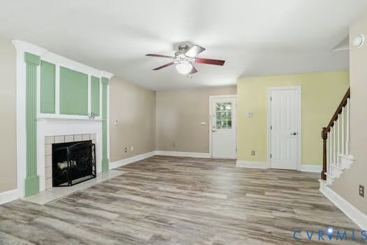 2804 Executive Drive, John Tyler Woods, Chester, VA 23831 Spacious room featuring Water proof LVP flooring, a decorative fireplace with a tile surround, and a ceiling fan.