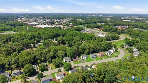 2804 Executive Drive, John Tyler Woods, Chester, VA 23831 Suburban residential area featuring a curved street, individual homes with landscaped yards, and mature trees
