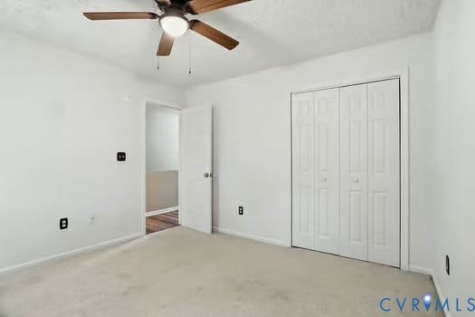 2804 Executive Drive, John Tyler Woods, Chester, VA 23831 Carpeted room featuring a new ceiling fan with integrated lighting, white walls, and bi-fold closet doors
