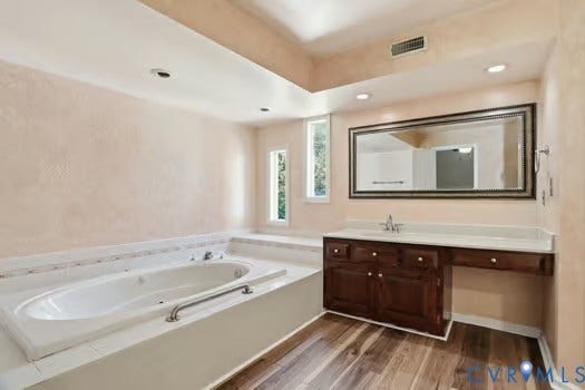 2804 Executive Drive, John Tyler Woods, Chester, VA 23831 Bathroom featuring a built-in jetted tub, water proof LVP flooring, and a vanity with a white countertop