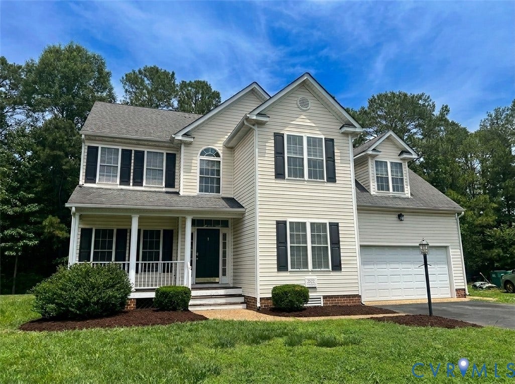 2532 Woodman Trace Drive, Glen Allen, VA 23060 Two-story residence featuring light-toned siding, dark shutters, an integrated garage, a covered front porch with white railings and columns, and a dormer window