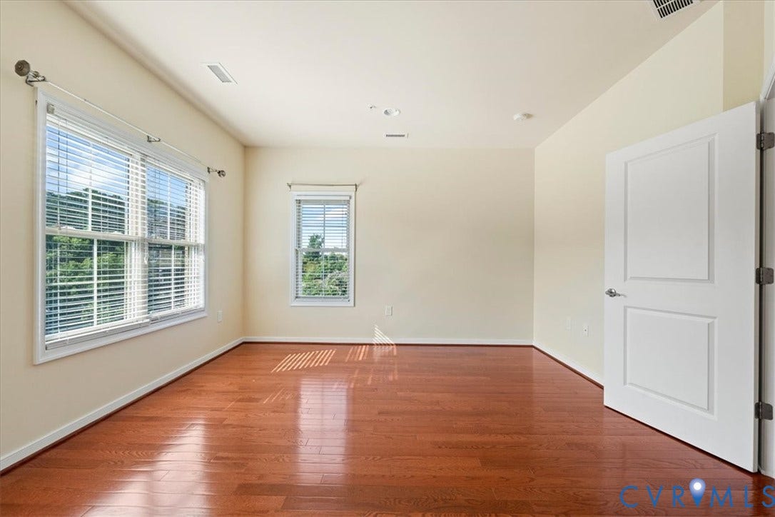 Third floor bathroom with en-suite full luxury bath Wood-finish flooring, recessed lighting, and multiple windows with blinds