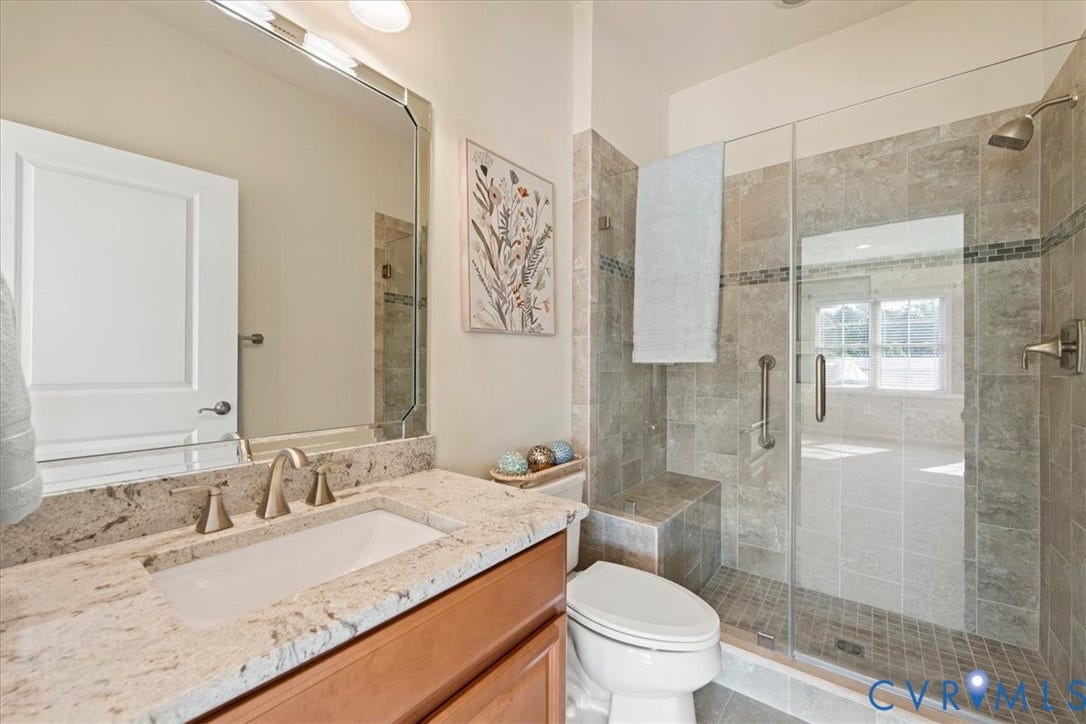 Forth floor Vanity with a light-toned granite countertop and an undermount sink