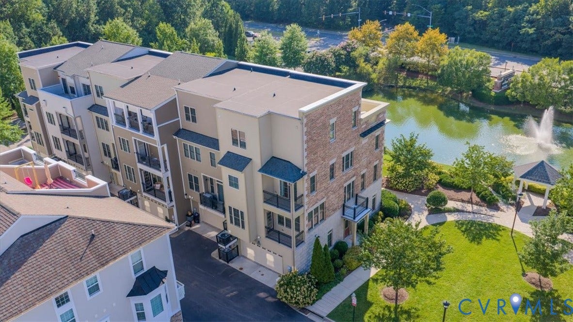 Multi-story residential buildings featuring balconies and stone-finish accents