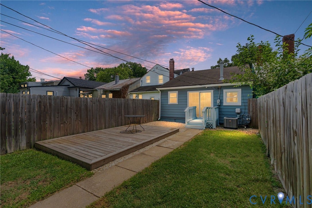 3314 Grayland Avenue, Richmond, VA 23221 Fenced backyard featuring a wood deck, concrete pathway, and green lawn