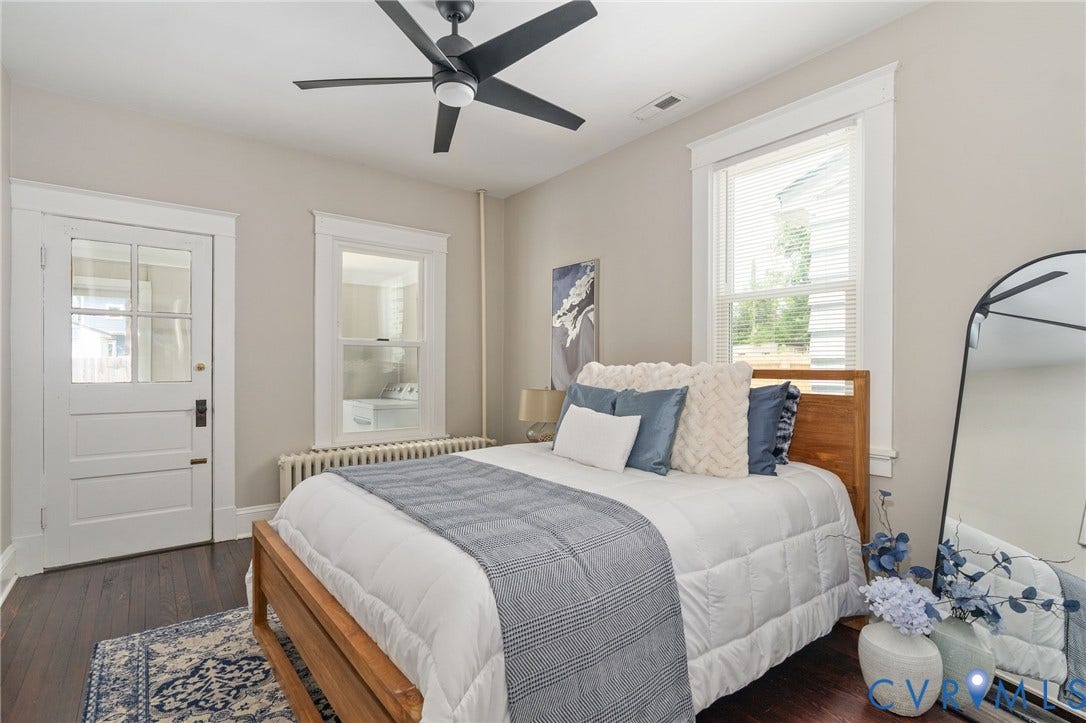3314 Grayland Avenue, Richmond, VA 23221 Bedroom featuring dark wood-finish flooring, two windows with white trim, a matte black ceiling fan, and a paneled door with glass inserts