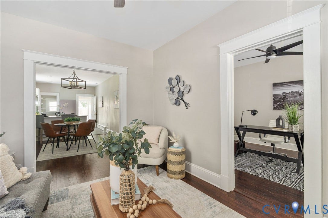 3314 Grayland Avenue, Richmond, VA 23221 Rich wood-finish flooring throughout, featuring a broad doorway to a distinct dining area with an overhead geometric chandelier