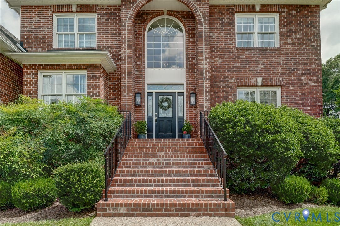 332 Rexmoor Terrace, Richmond, VA 23236 Brick exterior with an arched entry, prominent transom window, and white-framed windows