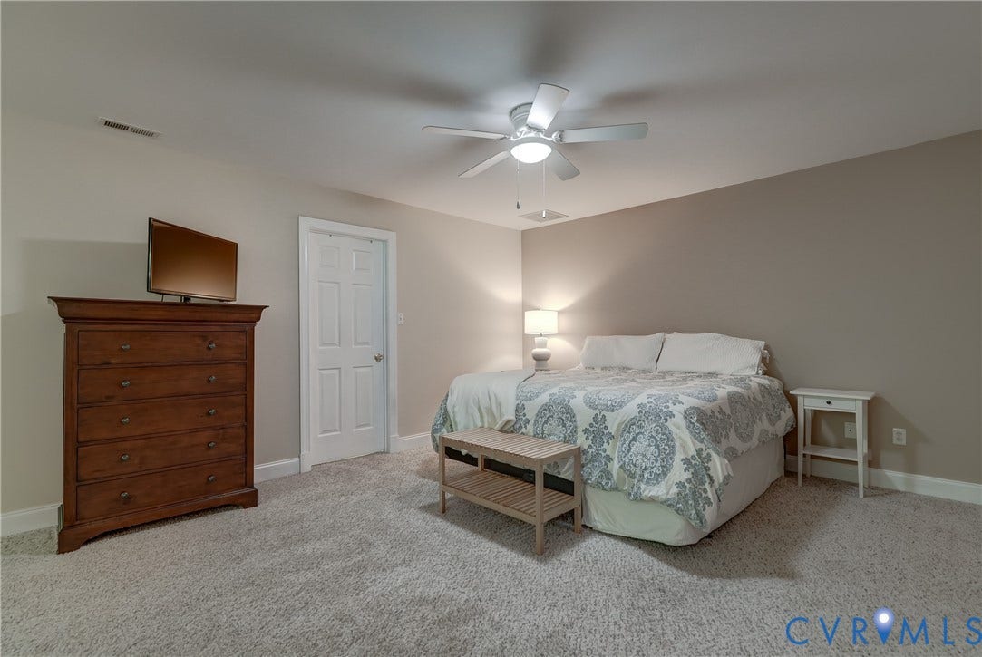 332 Rexmoor Terrace, Richmond, VA 23236 Carpeted room featuring neutral wall tones, a ceiling fan with integrated lighting, white trim, and a white paneled door