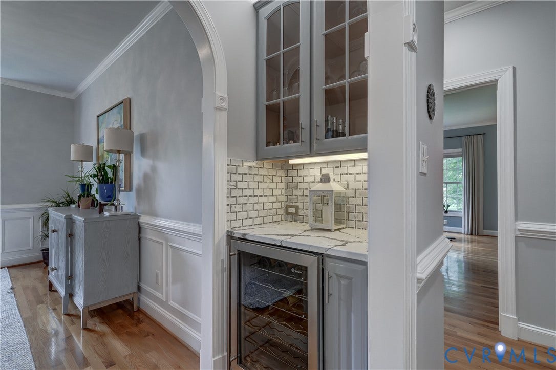 332 Rexmoor Terrace, Richmond, VA 23236 Built-in beverage bar featuring glass-front cabinetry, subway tile backsplash, under-cabinet lighting, and a beverage refrigerator
