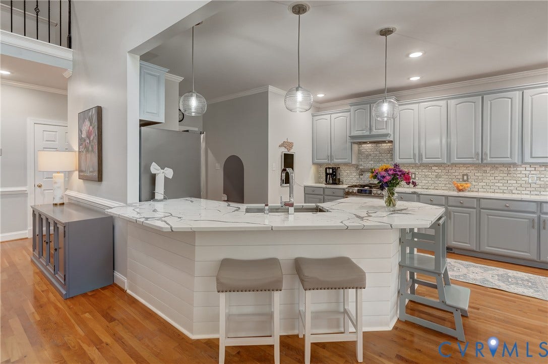 332 Rexmoor Terrace, Richmond, VA 23236 Kitchen featuring a multi-level island with a marble-finish countertop, white shiplap paneling, and pendant lighting