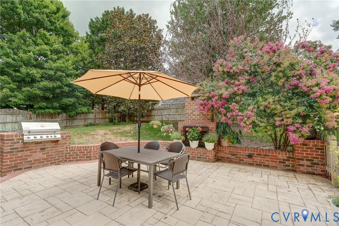 332 Rexmoor Terrace, Richmond, VA 23236 Stamped concrete patio featuring a built-in brick grill station and a mature flowering shrub