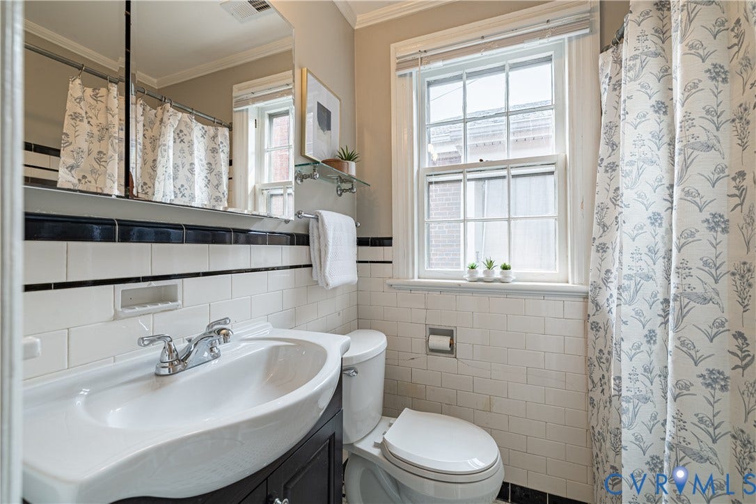 3903 Floyd Avenue, Richmond, VA 23221 Bathroom featuring a vanity with an integrated sink, a large mirror