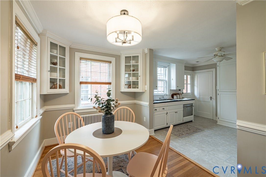 3903 Floyd Avenue, Richmond, VA 23221 Dining area with wood-finish flooring transitioning to kitchen with light-toned tile