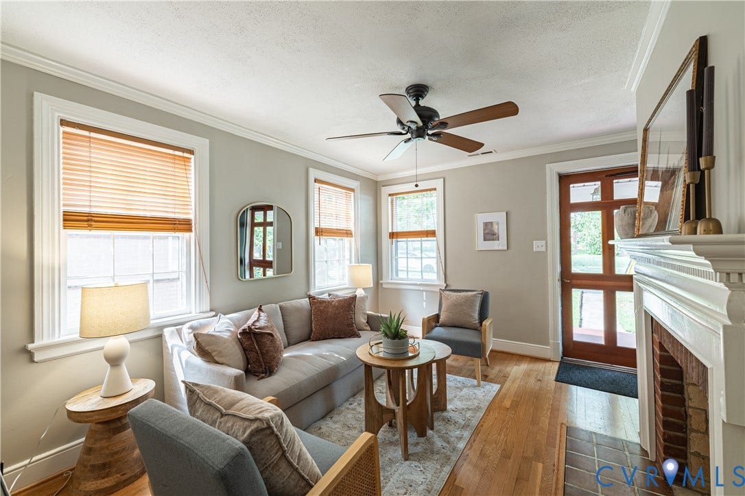 3903 Floyd Avenue, Richmond, VA 23221 Living room featuring wood-finish flooring, a ceiling fan with integrated lighting, and multiple windows with blinds